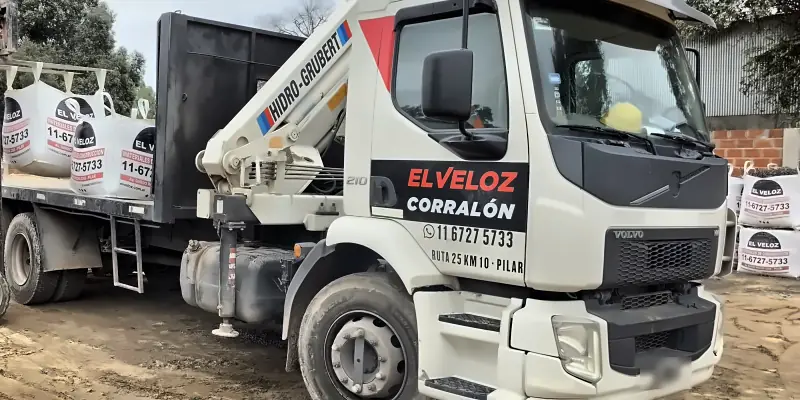 Camión con hidrogrúa de El Veloz cargando bolsones para una obra